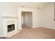 Bright and airy living room with a cozy fireplace, neutral paint, and plush carpeting at 207 Millwheel Dr, Villa Rica, GA 30180