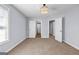 Bedroom with neutral carpet, light fixture, and multiple doors at 269 Legends Trce, Mcdonough, GA 30253