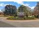 Scenic community entrance to Eagles Landing with decorative landscaping and signage surrounded by mature trees at 269 Legends Trce, Mcdonough, GA 30253