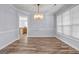Formal dining room boasting hardwood floors, modern chandelier, and ample natural light at 269 Legends Trce, Mcdonough, GA 30253