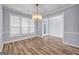 Elegant dining room with hardwood floors, crown molding, and a stylish chandelier at 269 Legends Trce, Mcdonough, GA 30253