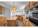 Spacious kitchen featuring wood cabinets, stainless steel appliances, and large center island at 269 Legends Trce, Mcdonough, GA 30253