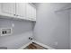 Laundry room with overhead cabinets and wood-look tile flooring at 269 Legends Trce, Mcdonough, GA 30253