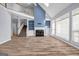 Bright living room with fireplace, large windows, and hardwood floors at 269 Legends Trce, Mcdonough, GA 30253