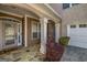 Covered porch with stone floor, white columns, and a charming porch swing at 269 Legends Trce, Mcdonough, GA 30253