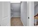 Small walk-in closet with shelving, neutral carpet, and an interior door at 269 Legends Trce, Mcdonough, GA 30253