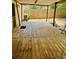 Outdoor porch with wooden deck and wooden roof overlooks the fenced backyard at 215 Highland Dr, Locust Grove, GA 30248
