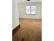 This bedroom features plush carpet and natural light from two windows at 215 Highland Dr, Locust Grove, GA 30248