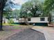 Charming single-story home with wood siding and a front porch at 215 Highland Dr, Locust Grove, GA 30248