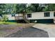 Charming single-story home with wood siding and a front porch at 215 Highland Dr, Locust Grove, GA 30248