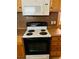 The kitchen features appliances including a range and microwave at 215 Highland Dr, Locust Grove, GA 30248