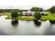 Stunning aerial view of a pristine white home featuring a private pool next to a tranquil lake at 1875 Highway 142 E, Covington, GA 30014