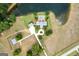 Areal view of stately residence with long driveway, guest house, lake, and green lawns at 1875 Highway 142 E, Covington, GA 30014