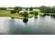 Expansive estate features a charming white home with a pool, overlooking a serene private lake at 1875 Highway 142 E, Covington, GA 30014