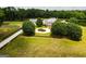 Stunning estate boasts a grand home, guest house, picturesque pond, and sprawling green lawns at 1875 Highway 142 E, Covington, GA 30014