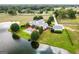 Aerial view of elegant estate with pool and guesthouse overlooking a private lake and expansive lawns at 1875 Highway 142 E, Covington, GA 30014