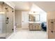 Well-lit bathroom with glass shower, vanity, and a stylish accent chair at 1875 Highway 142 E, Covington, GA 30014