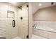 Modern bathroom with glass-enclosed shower featuring white subway tile and a separate soaking tub at 1875 Highway 142 E, Covington, GA 30014