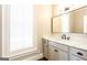 Bathroom with updated vanity, marble countertop, neutral color palette, and window allowing for natural light at 1875 Highway 142 E, Covington, GA 30014