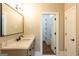 Bathroom featuring marble countertops, undermount sink and a view into the large walk in closet at 1875 Highway 142 E, Covington, GA 30014