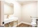 Modern bathroom featuring sleek fixtures, a stylish vanity, and a toilet with accessibility bar at 1875 Highway 142 E, Covington, GA 30014