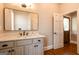 Bathroom features a sleek mirror, marble countertop and neutral-toned cabinetry at 1875 Highway 142 E, Covington, GA 30014