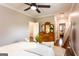 Bright bedroom featuring a ceiling fan, decorative mirror, and cozy seating area at 1875 Highway 142 E, Covington, GA 30014