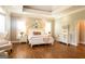 Bright bedroom featuring hardwood floors, tray ceilings, a comfortable bed and two large windows for ample sunlight at 1875 Highway 142 E, Covington, GA 30014