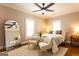 Cozy bedroom featuring soft lighting, a ceiling fan, and plush seating area at 1875 Highway 142 E, Covington, GA 30014