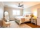 Inviting bedroom features neutral decor, ceiling fan, cozy seating, and wood floors at 1875 Highway 142 E, Covington, GA 30014