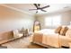 Serene bedroom featuring a plush bed, ceiling fan, accent chairs, and soft natural light at 1875 Highway 142 E, Covington, GA 30014