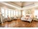 Spacious bedroom features hardwood floors, tray ceilings, and abundant natural light from the large bay window at 1875 Highway 142 E, Covington, GA 30014