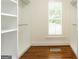 Walk-in closet featuring built-in shelving and wood floor at 1875 Highway 142 E, Covington, GA 30014