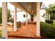 Beautifully tiled covered entrance featuring a wood door and view of landscaped surroundings at 1875 Highway 142 E, Covington, GA 30014