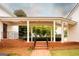 Covered entrance with brick steps and white columns offering a welcoming and elegant approach at 1875 Highway 142 E, Covington, GA 30014