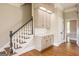 Staircase with hardwood steps and white risers, complemented by neutral walls and detailed trim at 1875 Highway 142 E, Covington, GA 30014