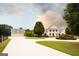 A large white home and detached garage with dormers set on a meticulously landscaped lot at 1875 Highway 142 E, Covington, GA 30014