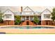 Striking home featuring a pool, a brick patio, and grand staircase leading to a covered porch at 1875 Highway 142 E, Covington, GA 30014