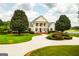 Beautiful home featuring a circular driveway, brick stairs, and manicured landscaping at 1875 Highway 142 E, Covington, GA 30014