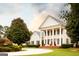 Impressive white home with symmetrical design, stately columns, and a circular driveway at 1875 Highway 142 E, Covington, GA 30014