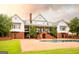 Elegant home with a white facade, brick accents, and a pool surrounded by brick pavers at 1875 Highway 142 E, Covington, GA 30014