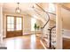 Elegant foyer showcasing a beautiful curved staircase, hardwood floors, and natural light at 1875 Highway 142 E, Covington, GA 30014