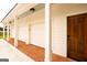 Attached three-car garage and side entrance to covered entrance of home at 1875 Highway 142 E, Covington, GA 30014