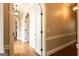 Hallway featuring arched entryways, dark hardware and hardwood flooring throughout the home at 1875 Highway 142 E, Covington, GA 30014
