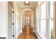 Elegant hallway features arched doorways and hardwood flooring illuminated by modern light fixtures at 1875 Highway 142 E, Covington, GA 30014