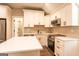 Modern kitchen with white cabinets, quartz countertops, and stainless steel appliances at 1875 Highway 142 E, Covington, GA 30014