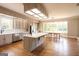 Spacious kitchen boasts stainless steel appliances, a large island, and beautiful wood flooring at 1875 Highway 142 E, Covington, GA 30014