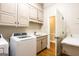 Light-filled laundry room features modern appliances, marble counters, and ample storage at 1875 Highway 142 E, Covington, GA 30014