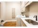 Bright laundry room boasts marble countertops and cabinetry, blending functionality with style at 1875 Highway 142 E, Covington, GA 30014