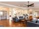 Open-concept living room boasting hardwood floors, coffered ceilings, columns, and an open staircase at 1875 Highway 142 E, Covington, GA 30014